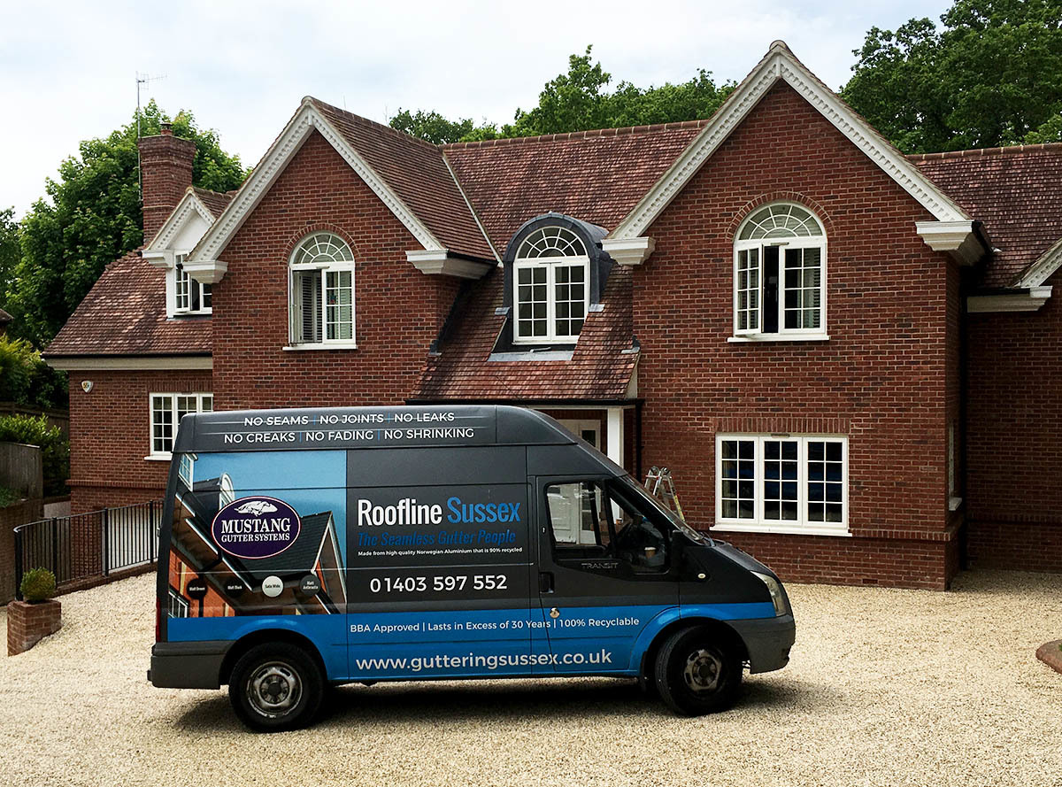 A recently installed Mustang Gutter system on a large property. The Roofline Sussex van is parked in front.
